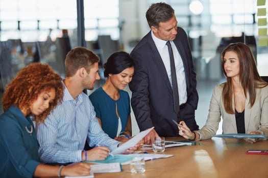 Building a real personal connection with your teammates is vital. a group of businesspeople having a meeting in the boardroom.