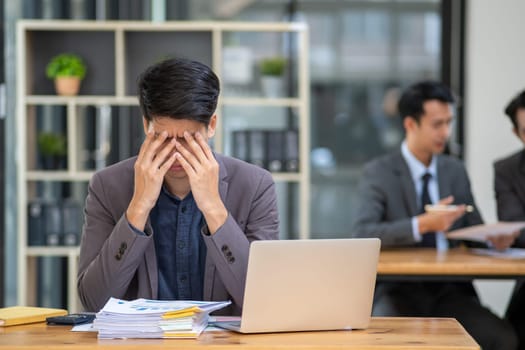 Young business man feeling tired stressed concern upset nervous serius in office, business employee exhausted sad disappointed frustrated burn out at desk. High quality photo