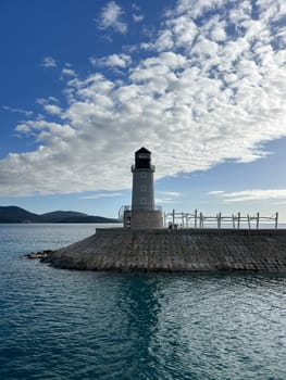 Lighthouse on a breakwater against a cloudy sky