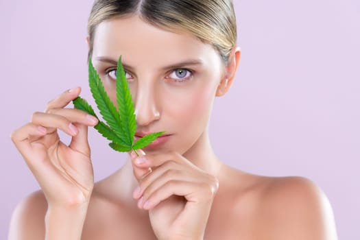 Closeup alluring woman portrait hold green leaf as cannabis beauty concept.
