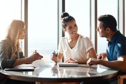 Achieving financial freedom with the expert advice. a young couple meeting with a financial planner in a modern office