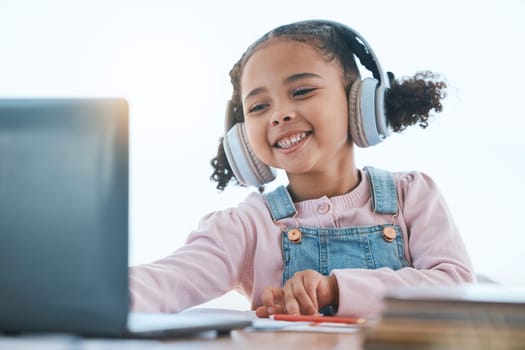 Computer, headphones and child listening in virtual class for e learning, language translation or knowledge at home. Happy kid on audio technology, laptop and online education for English development.