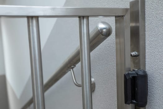 Stainless steel barrier as a safety device to prevent people from climbing the staircase.