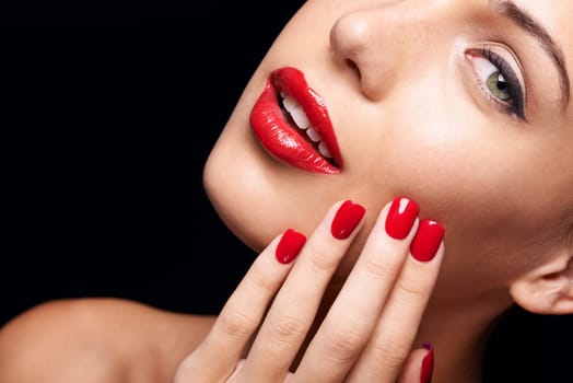 Beauty, makeup and woman with red lipstick and nails in a studio with a self care pamper treatment. Cosmetic, portrait and half face closeup of female model with a facial routine by black background.