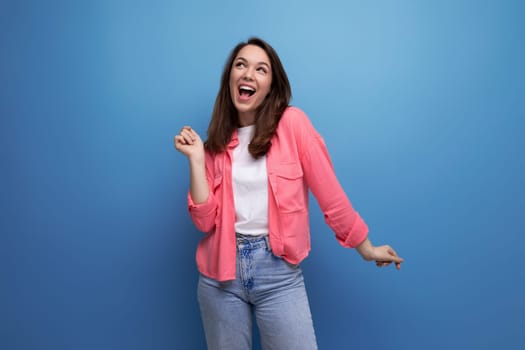 cheerful positive brunette young female adult in a shirt with joyful emotions on an isolated background