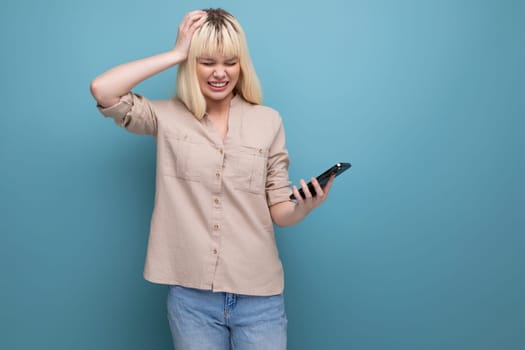 stressed blonde european young woman with a phone in her hands