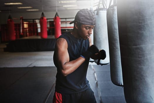 The toughest opponent of all is the one inside your head. a kick-boxer training in a gym.