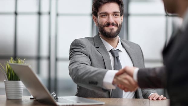 business man greets the employee with a handshake,