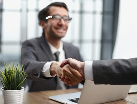 handshake of business partners at a meeting in the office