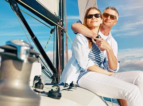 Going on a second honeymoon can rejuvenate your marriage. a couple enjoying a boat cruise out on the ocean.