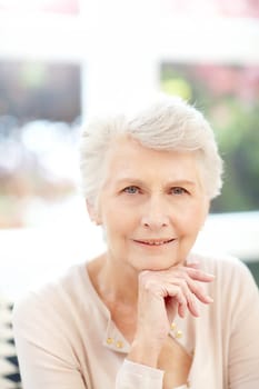 Sophisticated style. Portrait of a happy elderly woman enjoying a relaxing day at home.
