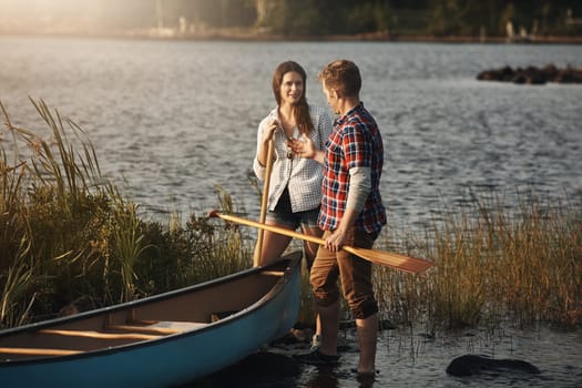Canoeing, great outdoor date fun. a young couple going for a canoe ride on the lake.