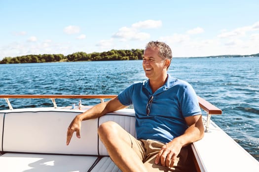 Making retirement even better with a relaxing boat ride. a mature man enjoying a relaxing boat ride.