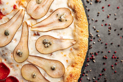 Gourmet pizza with pear and gorgonzola cheese