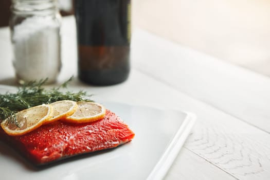 It packs a flavor and protein punch. a raw piece of meat garnished with slices of lemon.