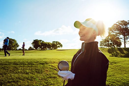 Happiness is a leisurely round of golf. a woman spending the day on a golf course.