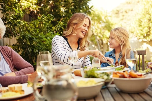 Love and food are meant to be shared. a family eating lunch together outdoors.