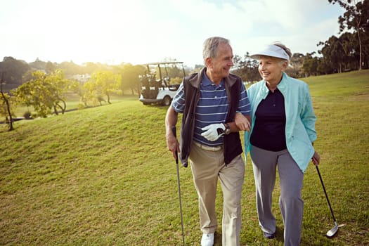 I knew youd enjoy it. a smiling senior couple enjoying a day on the golf course.