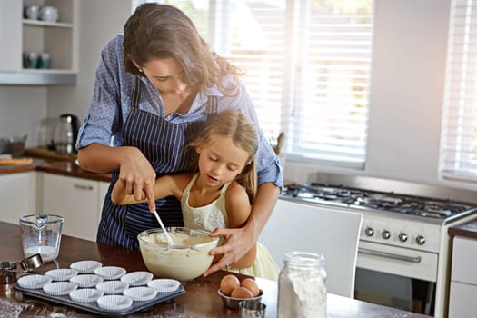 Creating lasting memories. a mother and her daughter baking in the kitchen.