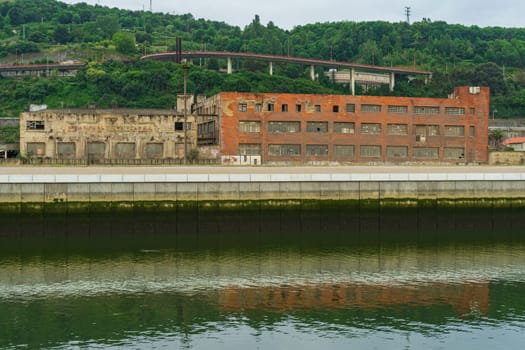 Abandoned industrial buildings along the Nervion River, Bilbao Basque Country, Spain.
