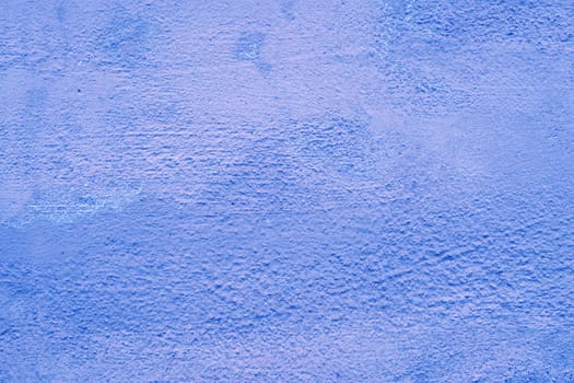 Texture of an old damaged wall toned in blue.