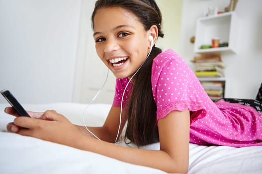 Just me and a rocking playlist. a teenage girl listening to music in her bedroom.