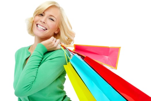 Swirling her shopping bags through the air. An excited young woman holding shopping bags while isolated on a white background.