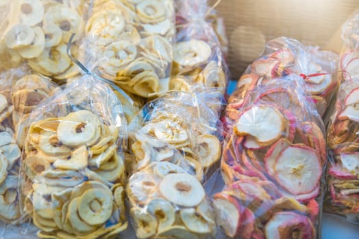 Preparation of dried fruits. Slices of dried apples are laid out in plastic bags. Eating dried fruits in winter.