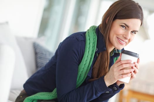Enjoying that first soothing sip on a cold day. Portrait of a gorgeous young woman drinking coffee.