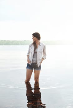 The whole nature all to myself. an attractive young woman standing in a lake.