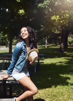 Time to chill out and enjoy the sunny days. an attractive young woman spending a day in the park.