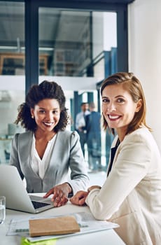 Youve got to take an active role in finding success. Portrait of a two corporate businesswomen working together in an office.