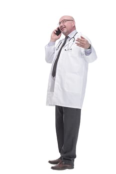 mature doctor with smartphone. isolated on a white background.