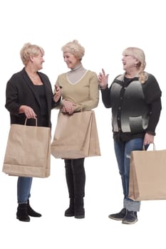 in full growth. three happy women with shopping bags.