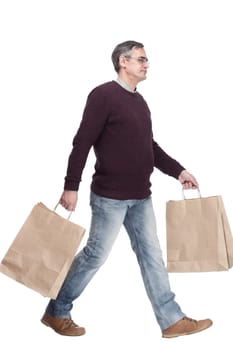 full-length. casual man with shopping bags. isolated on a white