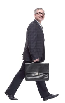 confident man with briefcase striding forward. isolated on a white