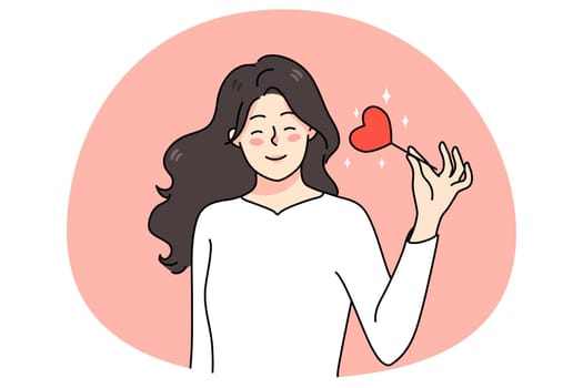 Smiling woman hold heart on stick