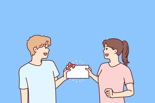 Man and woman with gift certificate in hands rejoice at receiving invitation card