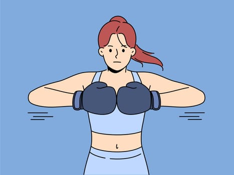 Strong woman in boxing gloves ready for fight