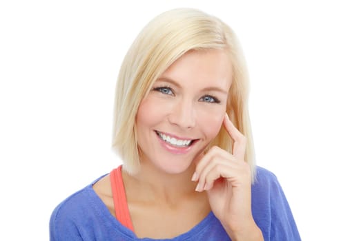 Endearing smile. Head and shoulders portrait of a beautiful young blonde isolated on a white background.
