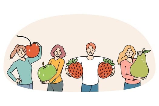 Happy people holding fruit recommend healthy diet