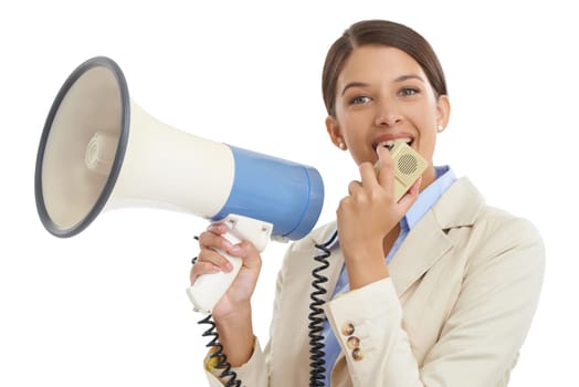 Making herself heard. an attractive young businesswoman speaking on a megaphone.