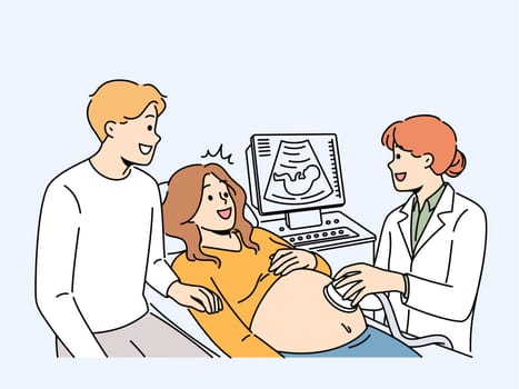 Happy future parents on ultrasound in clinic