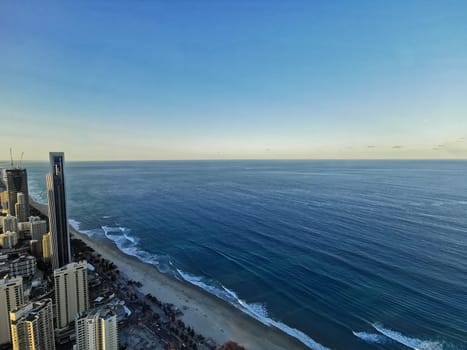 GOLD COAST, AUSTRALIA - APRIL 25, 2021: Aerial panorama view of High-rise building sky scrapers in Surfer Paradise beach and Pacific ocean landscape with Sunset light in the evening.