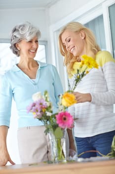 Getting some quality time with Mom. a senior woman enjoying some flower arranging with her daughter.