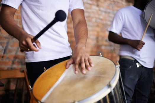 Playing to the Brazilian beat. a band playing their percussion instruments in a Brazilian setting.
