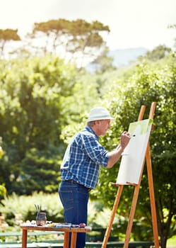 Find your passion. a senior man painting in the park.