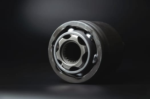 Auto CV joint Connecting the drive shaft on a black background. New hinges of equal angular speeds. New car CV joints. Quality spare parts for car service or repair