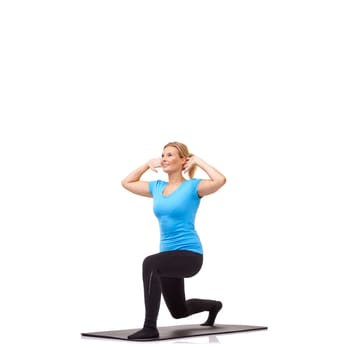 Lunges. A young woman performing a routine on her exercise mat while isolated on white.