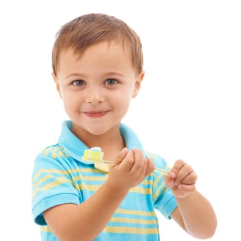Its a big boy toothbrush. Portrait of a young boy holding a toothbrush isolated on white.